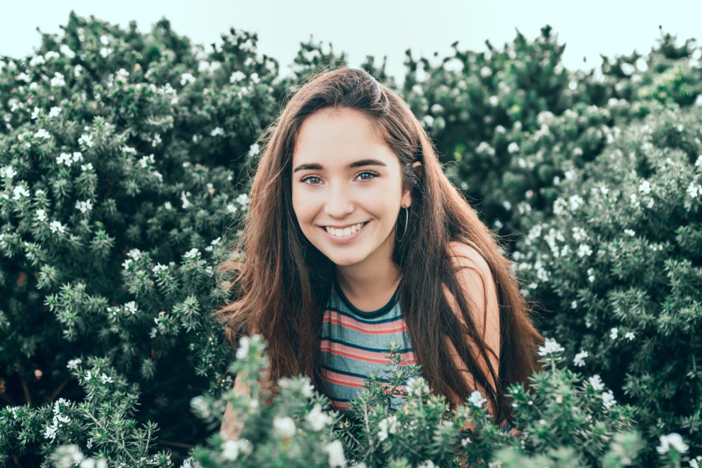 Smiling girl betwin plants